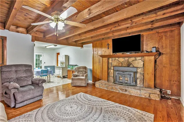 a kitchen with granite countertop a stove a refrigerator and a dining table