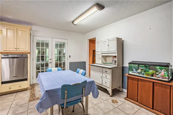 a kitchen with granite countertop a stove a refrigerator and a dining table