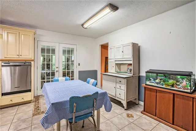 a kitchen with cabinets stainless steel appliances a sink and a window