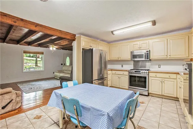 a kitchen with a wooden table and chairs