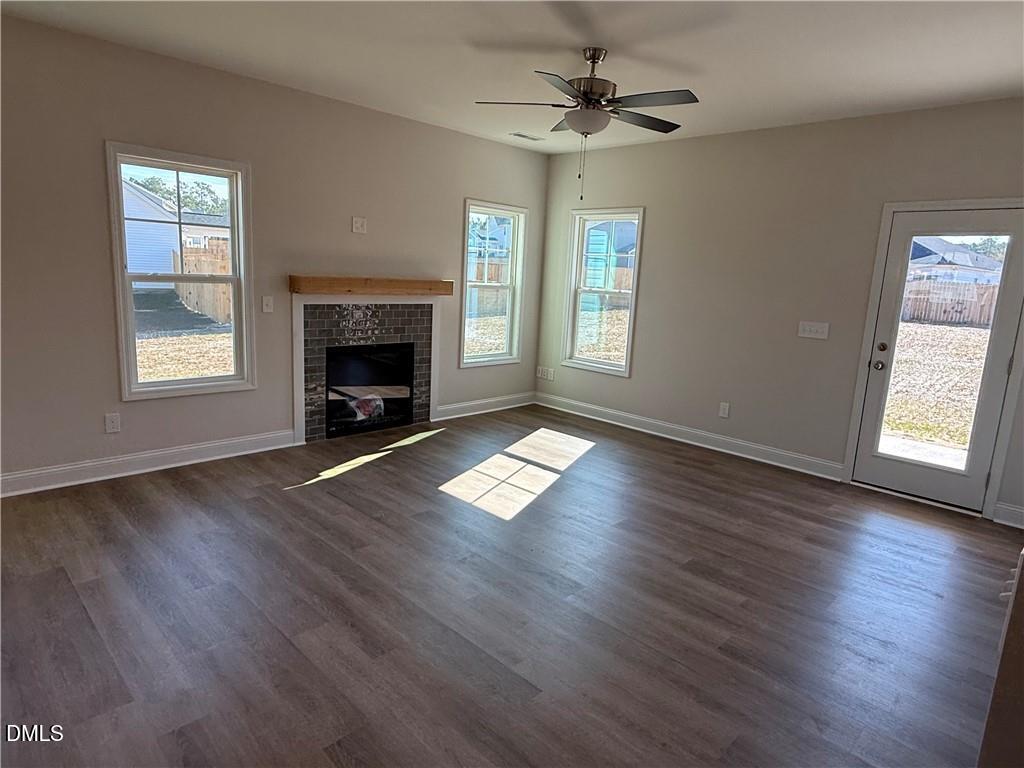 244 Godwin Gate Street, Unit 56 Linden, NC 28356 - Photo 6 of 21 a view of an empty room with wooden floor fireplace and a window