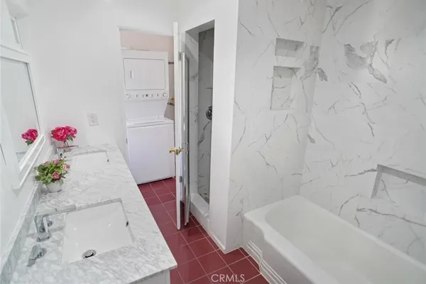 a bathroom with a tub shower and sink