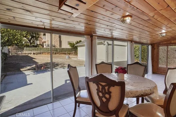a view of a dining room with furniture large windows and wooden floor