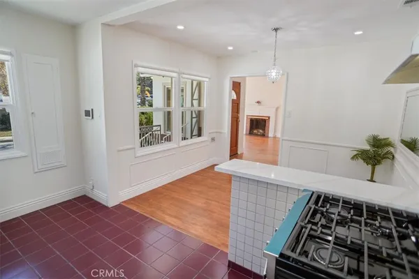 a very nice looking room with a large window and stainless steel appliances