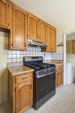 a kitchen with a stove top oven