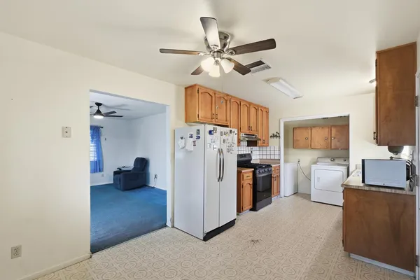 a view of a kitchen with a refrigerator and a sink