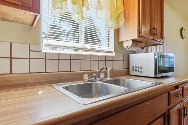 a kitchen with a sink and a window