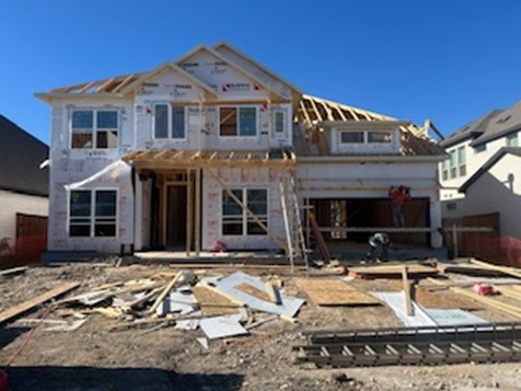 a front view of a house with yard outdoor seating and garage