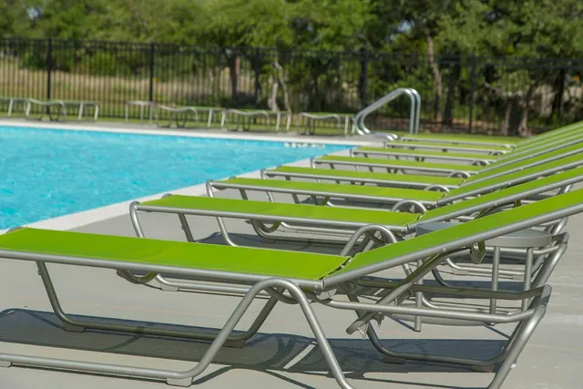 a view of outdoor space with seating area and trees in the background