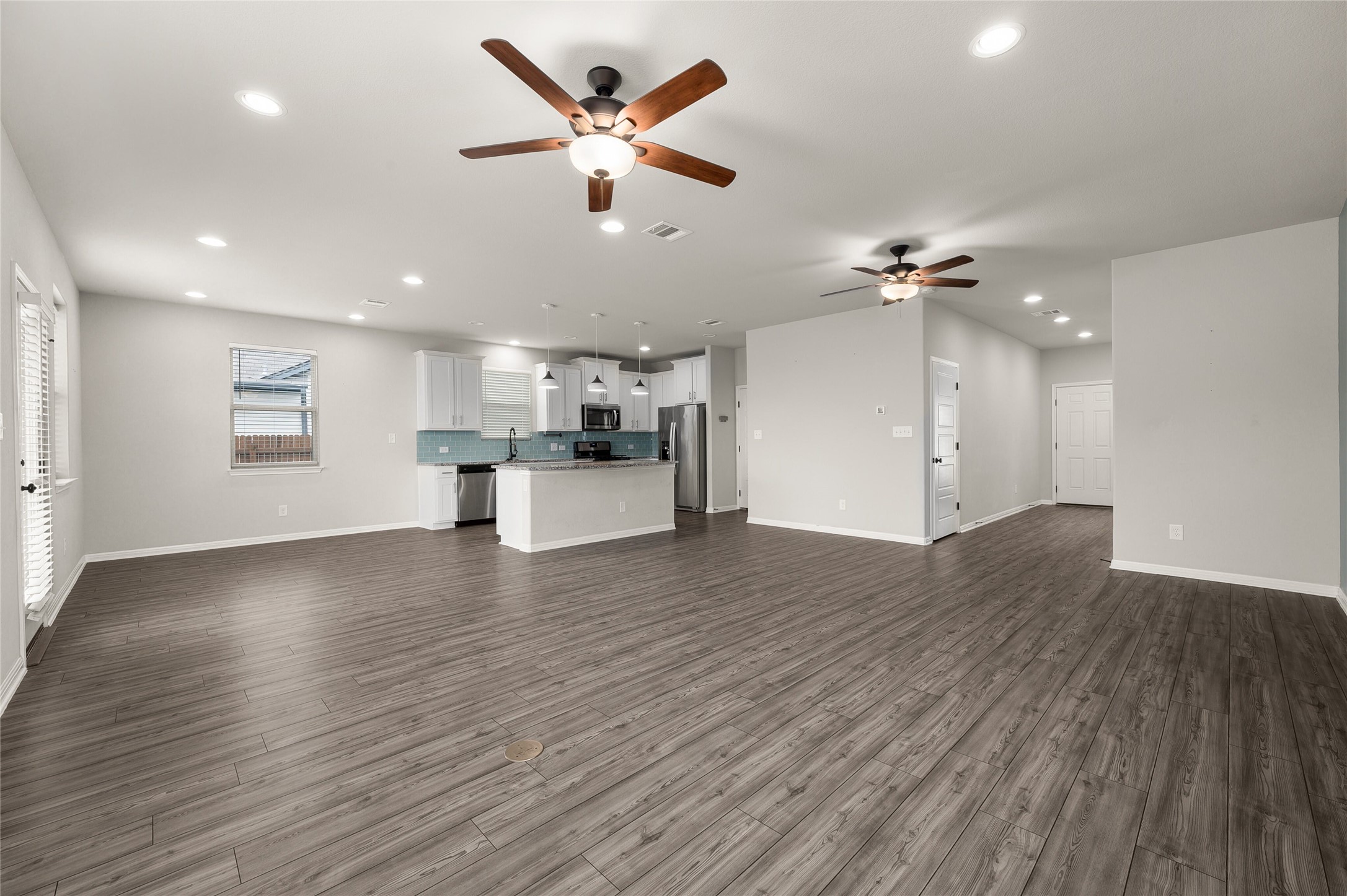 101 Lambert Street Leander, TX 78641 - Photo 33 of 33 An open floorplan seamlessly connects the kitchen and living areas, offering ample space for comfortable living.