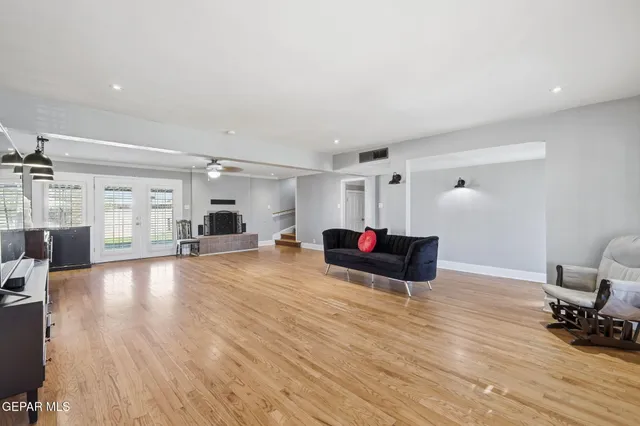 a living room with furniture and a wooden floor