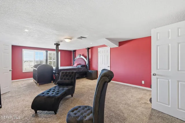 a living room with furniture ceiling fan and a window