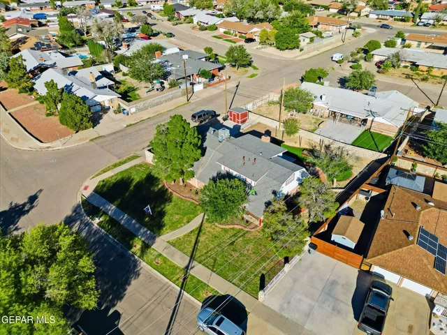 an aerial view of a house with a yard