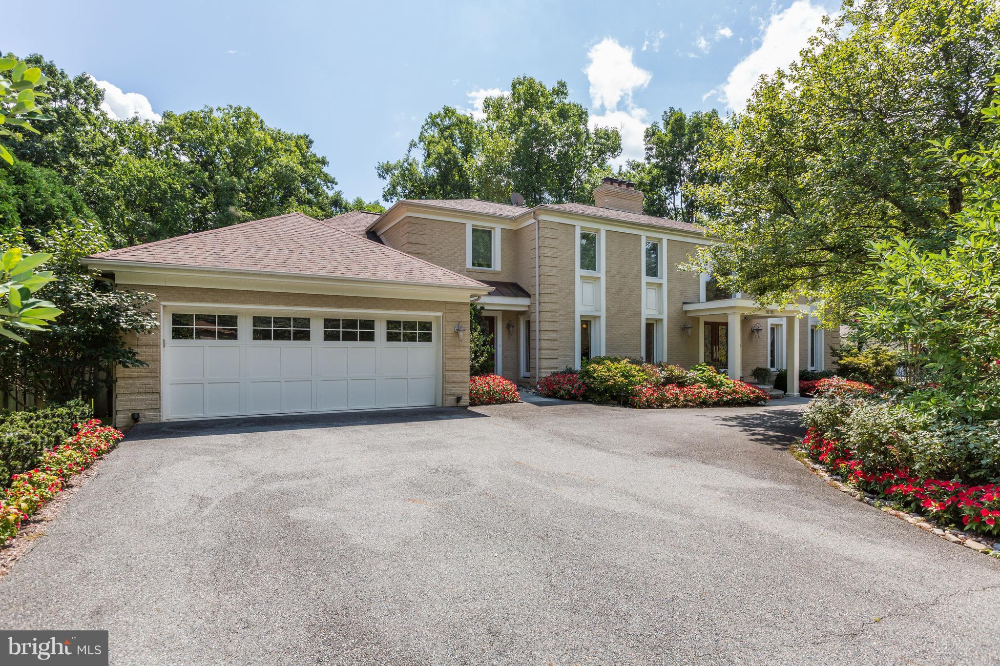 10101 Ormond Road Potomac, MD 20854 - Photo 2 of 30 a front view of a house with a garden and trees