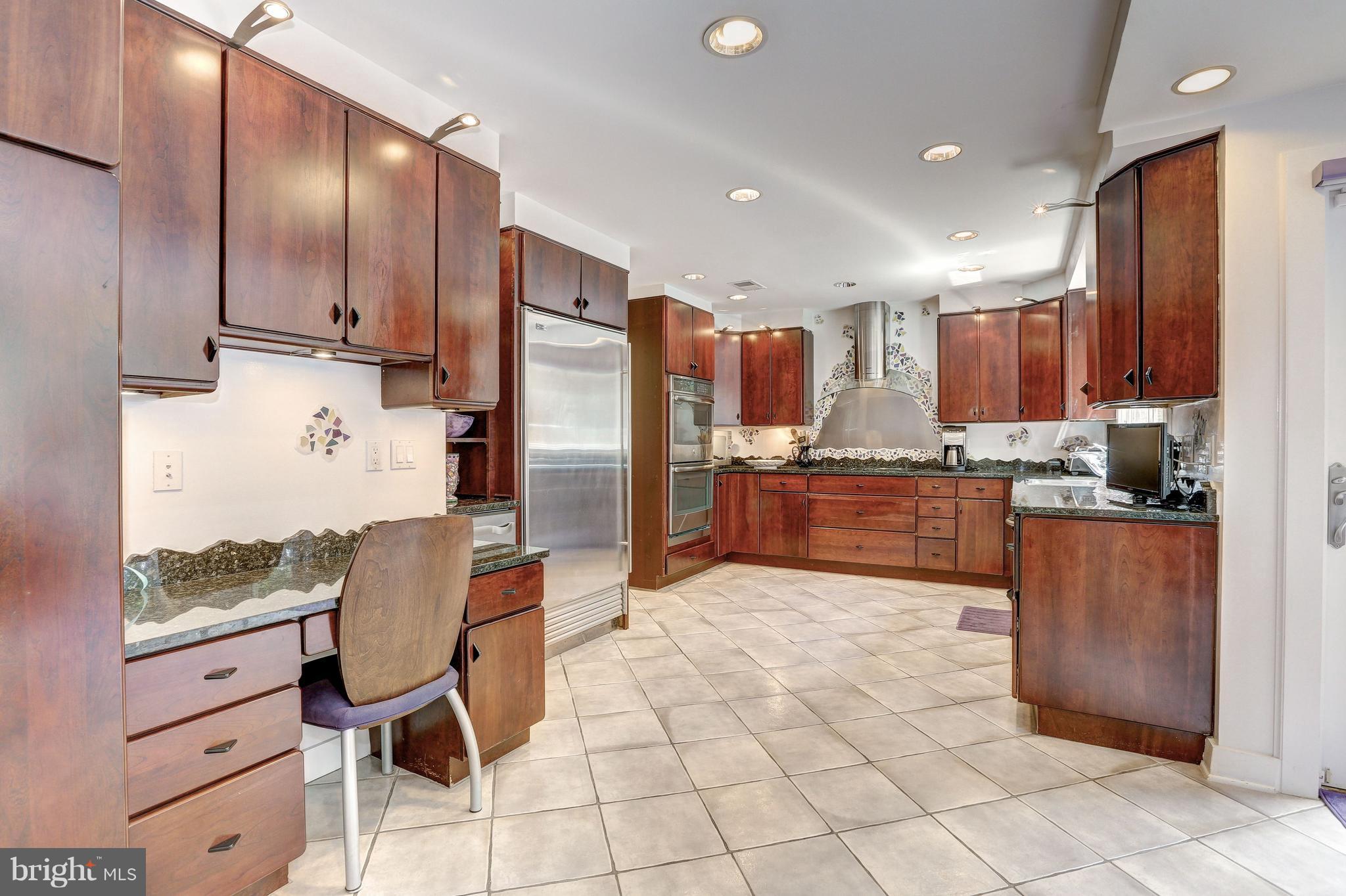10101 Ormond Road Potomac, MD 20854 - Photo 12 of 30 a kitchen with granite countertop cabinets and steel stainless steel appliances