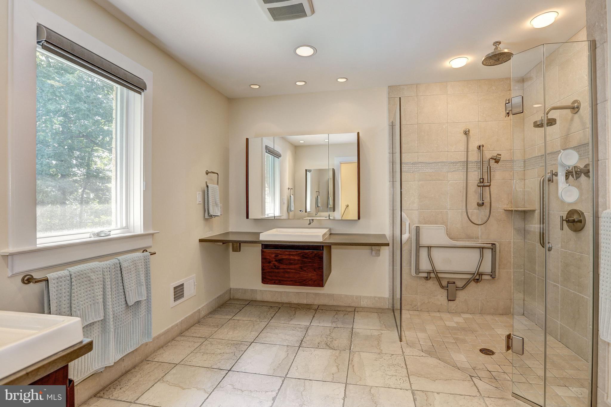 10101 Ormond Road Potomac, MD 20854 - Photo 18 of 30 a bathroom with a tub shower and sink