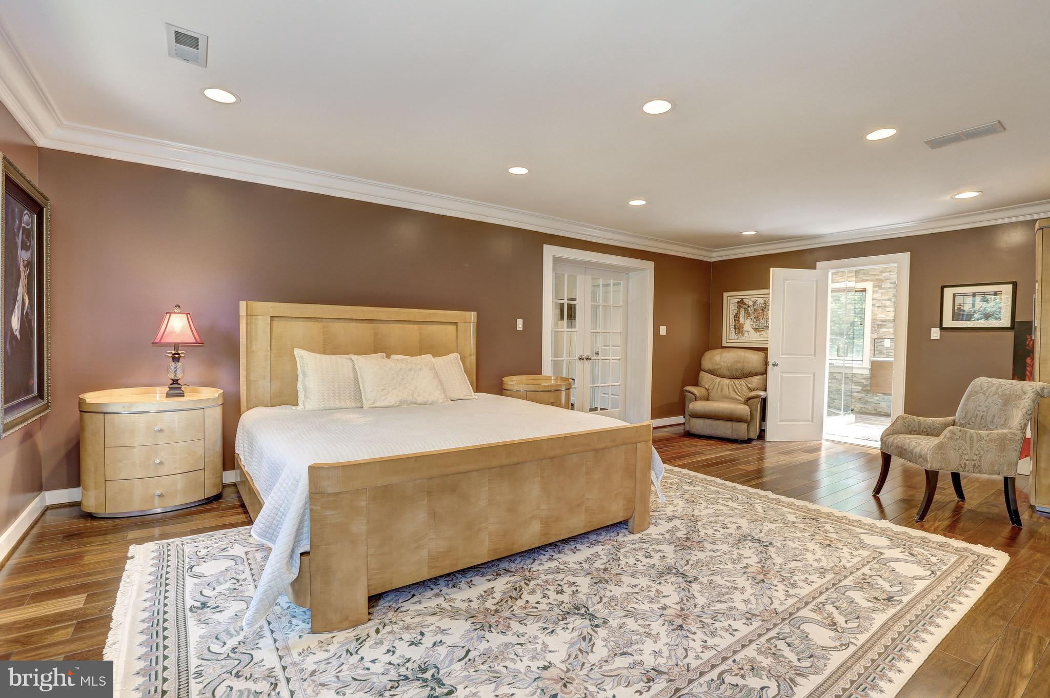 10101 Ormond Road Potomac, MD 20854 - Photo 19 of 30 a bedroom with a bed and wooden floor