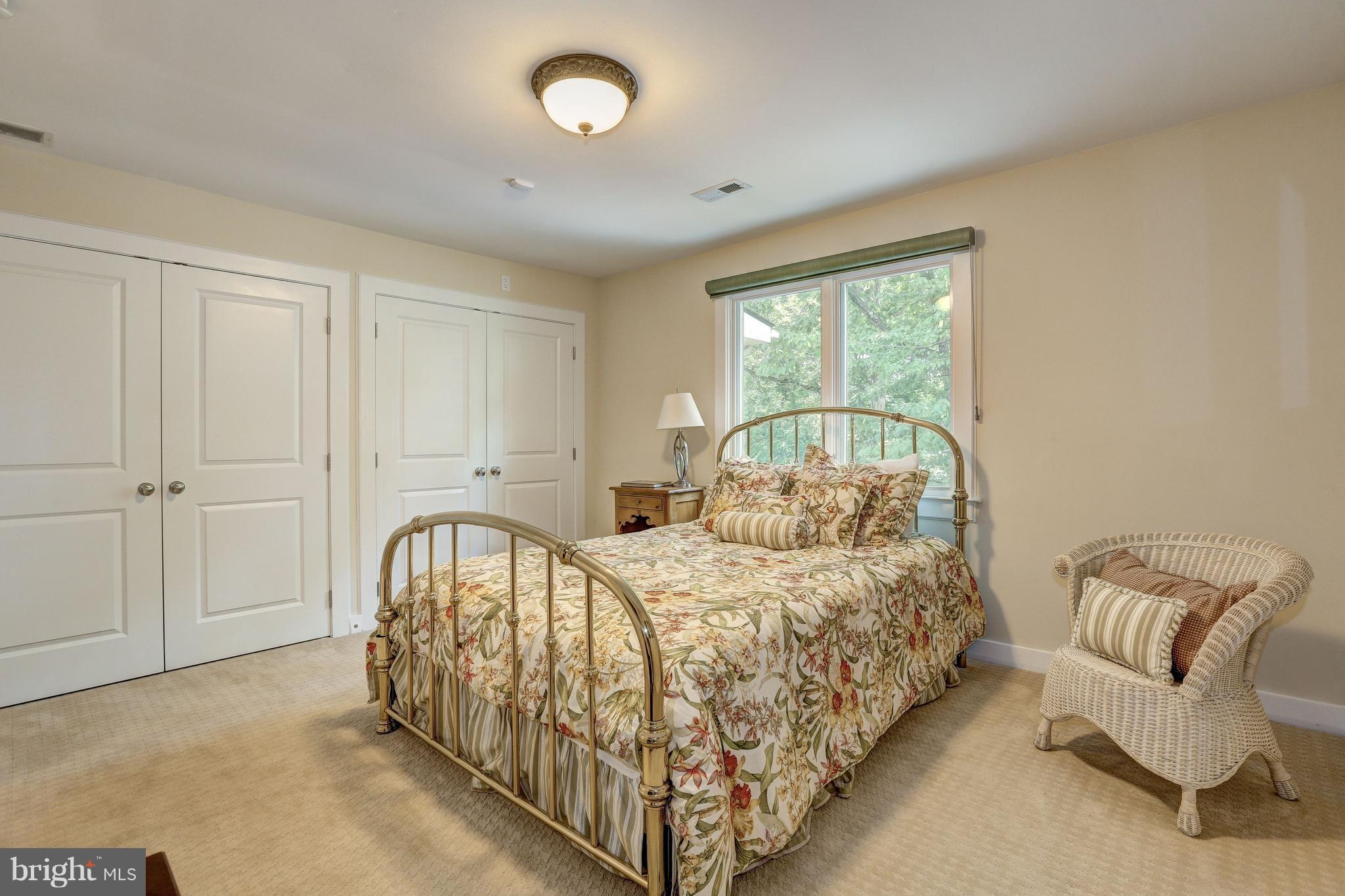 10101 Ormond Road Potomac, MD 20854 - Photo 27 of 30 a bed sitting in a spacious bedroom next to a window