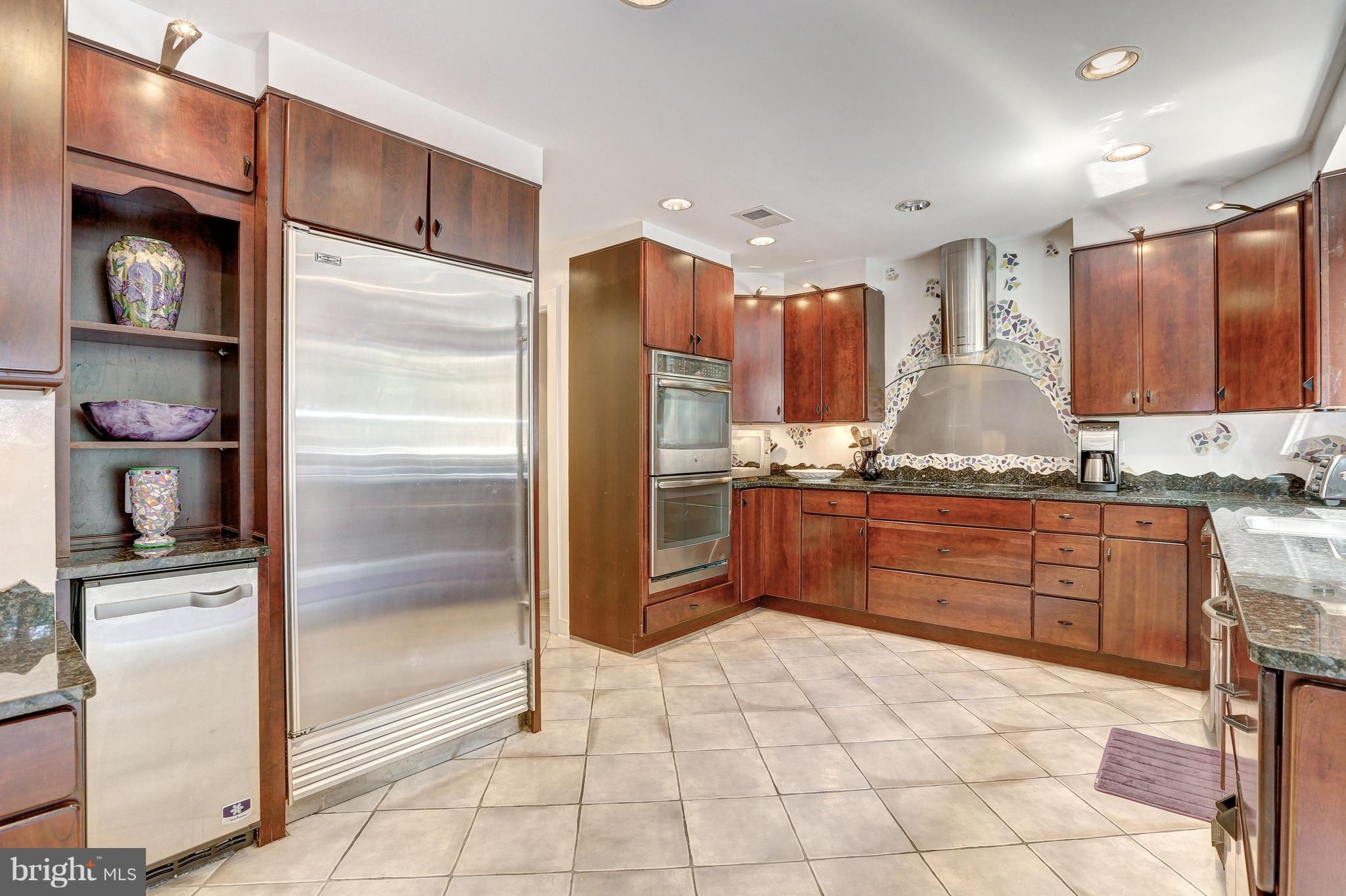 10101 Ormond Road Potomac, MD 20854 - Photo 10 of 30 a kitchen with stainless steel appliances granite countertop a refrigerator and a sink