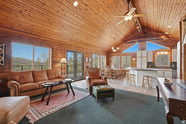 6 Beaver Springs Rancheros Oakley, UT 84055 - Photo 13 of 68 Open-concept living area with extensive wood paneling throughout walls and vaulted ceiling