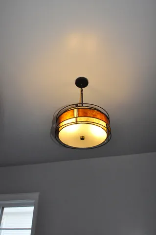 a bedroom with a bed and a dresser next to a window