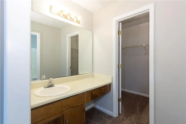 a bathroom with a sink a light fixture and a mirror