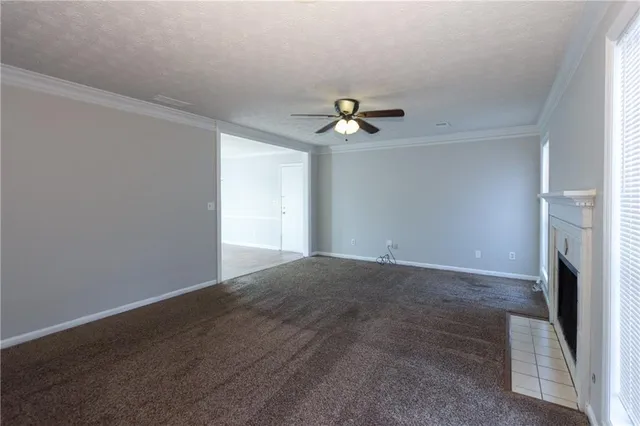 a view of a livingroom with a ceiling fan and window