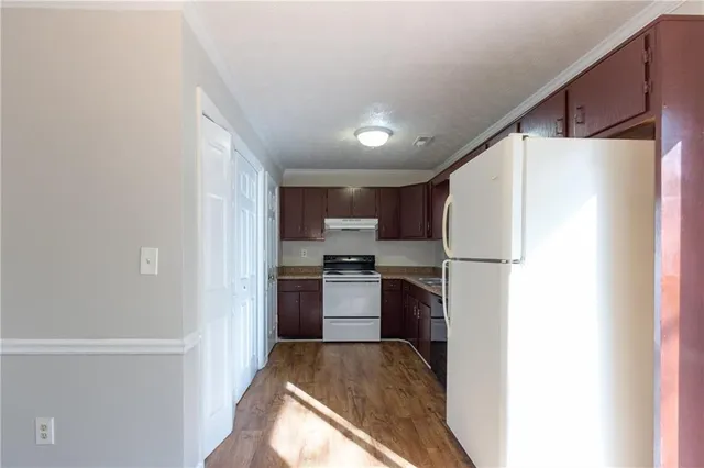 a kitchen with refrigerator and stove