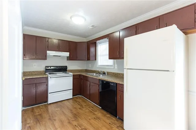 a kitchen with a refrigerator and a stove