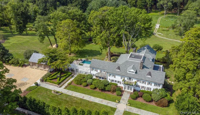 a view of a house with a yard and potted plants