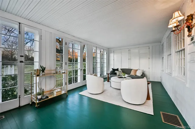 a living room with furniture a rug and a large window