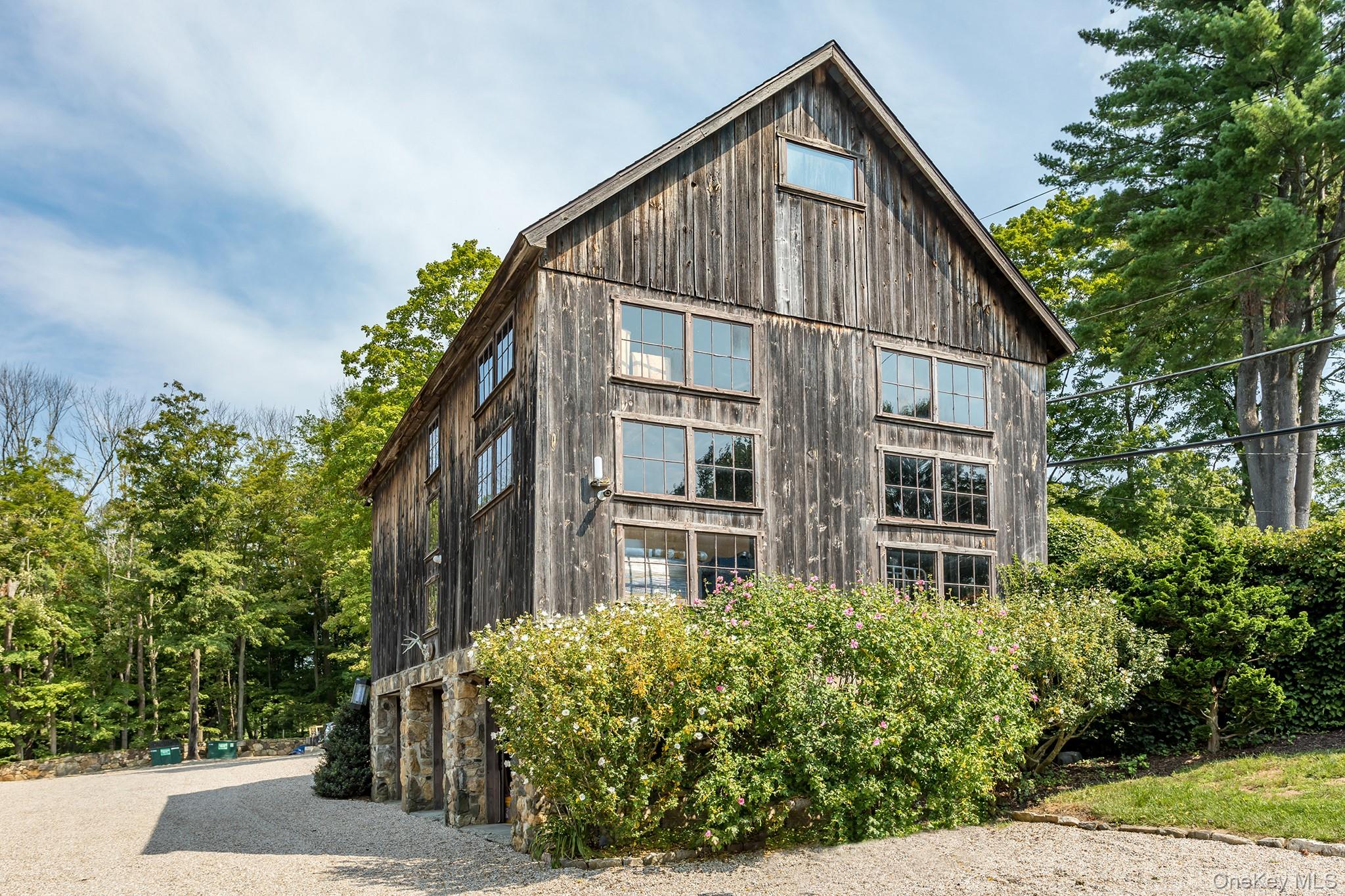 151-155 Long Ridge Road Danbury, CT 06810 - Photo 35 of 48 a view of a house with brick walls and flower plants
