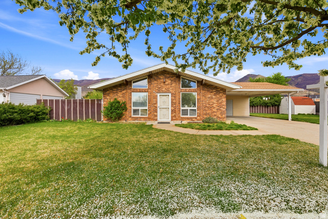 638 North 800 West Centerville, UT 84014 - Photo 1 of 1 View of front of property with a carport, concrete driveway, brick siding, and a mountain view