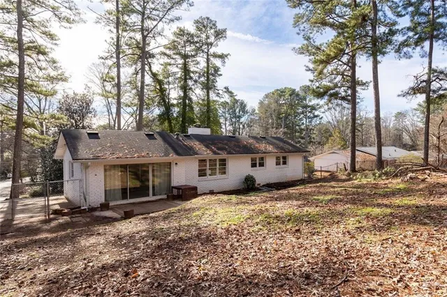 a view of a house with a yard covered in snow