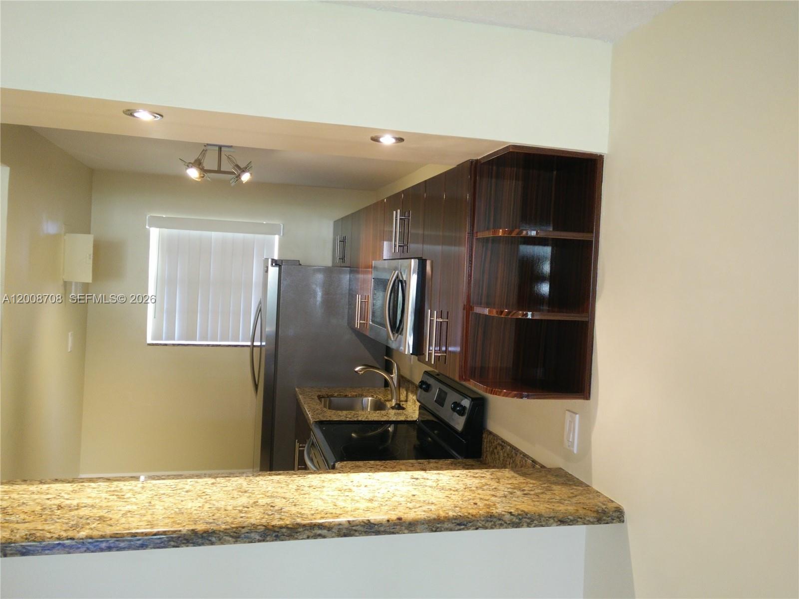 3285 Foxcroft Road, Unit E107 Miramar, FL 33025 - Photo 3 of 12 a view of a kitchen with a sink