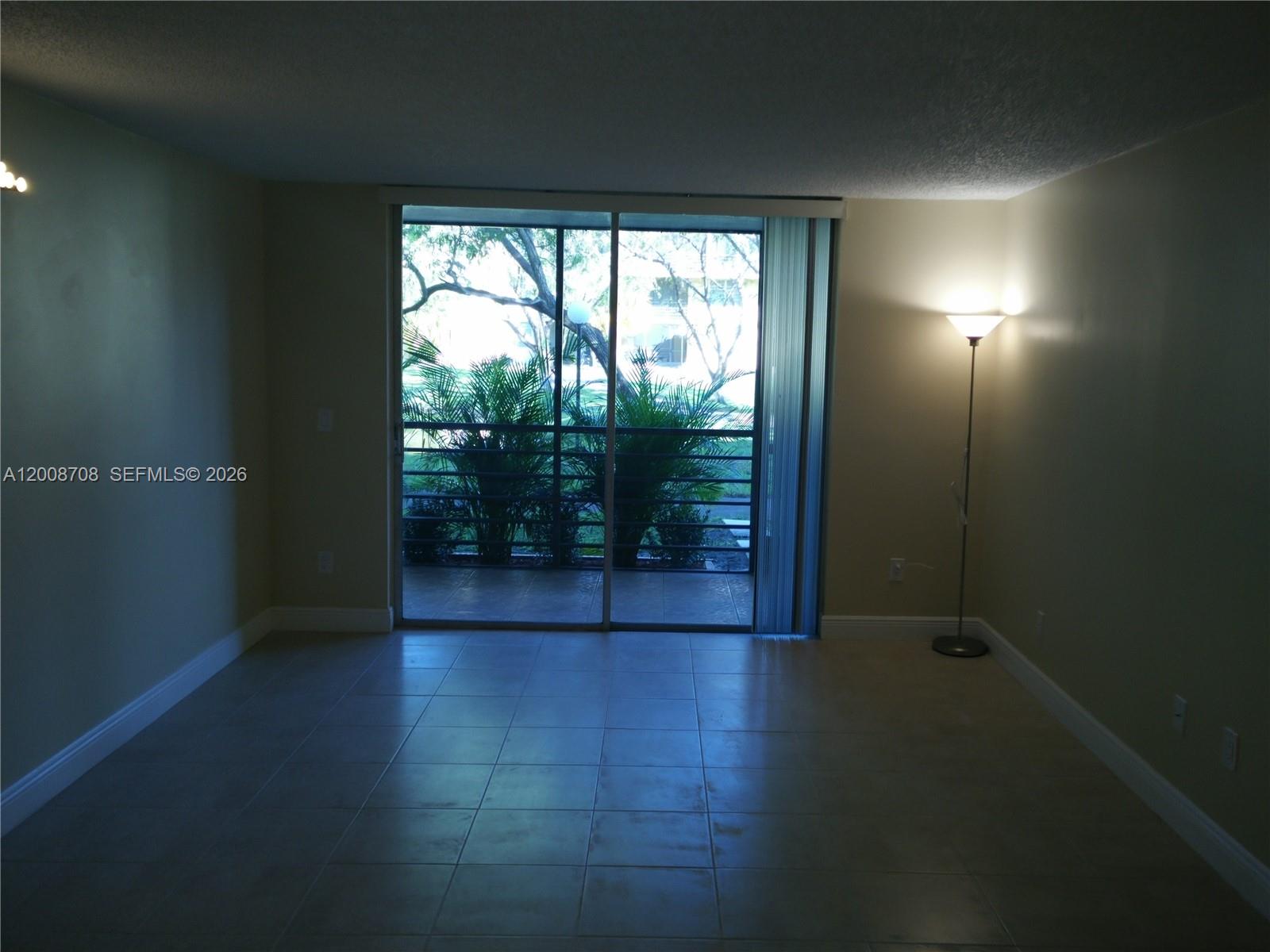3285 Foxcroft Road, Unit E107 Miramar, FL 33025 - Photo 6 of 12 a view of empty room with wooden floor and fan