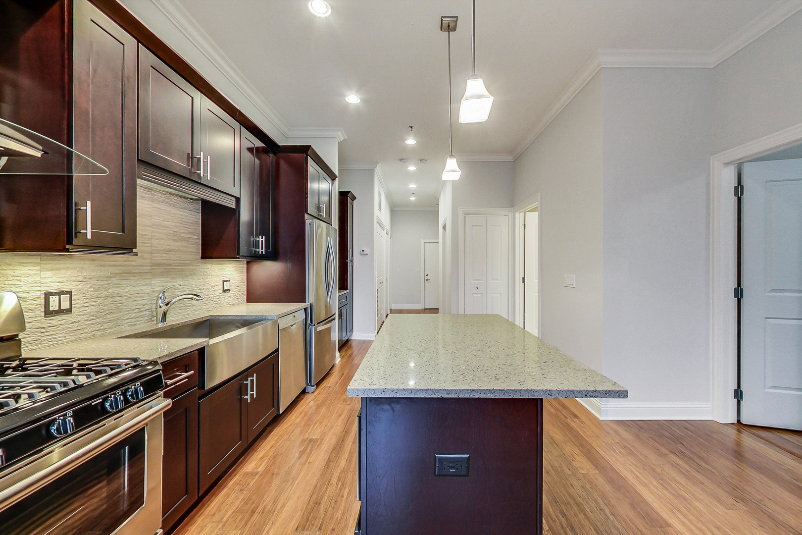 1247 West Madison Street, Unit 310 Chicago, IL 60607 - Photo 3 of 11 a kitchen with stainless steel appliances granite countertop a sink stove and refrigerator