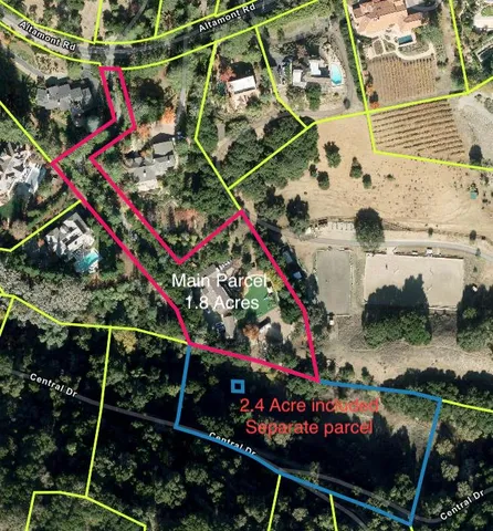 an aerial view of a residential houses with yard