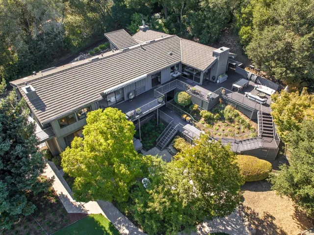 a aerial view of a house with table and chairs and potted plants