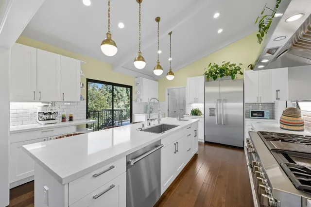 a kitchen with a stove and a white cabinets