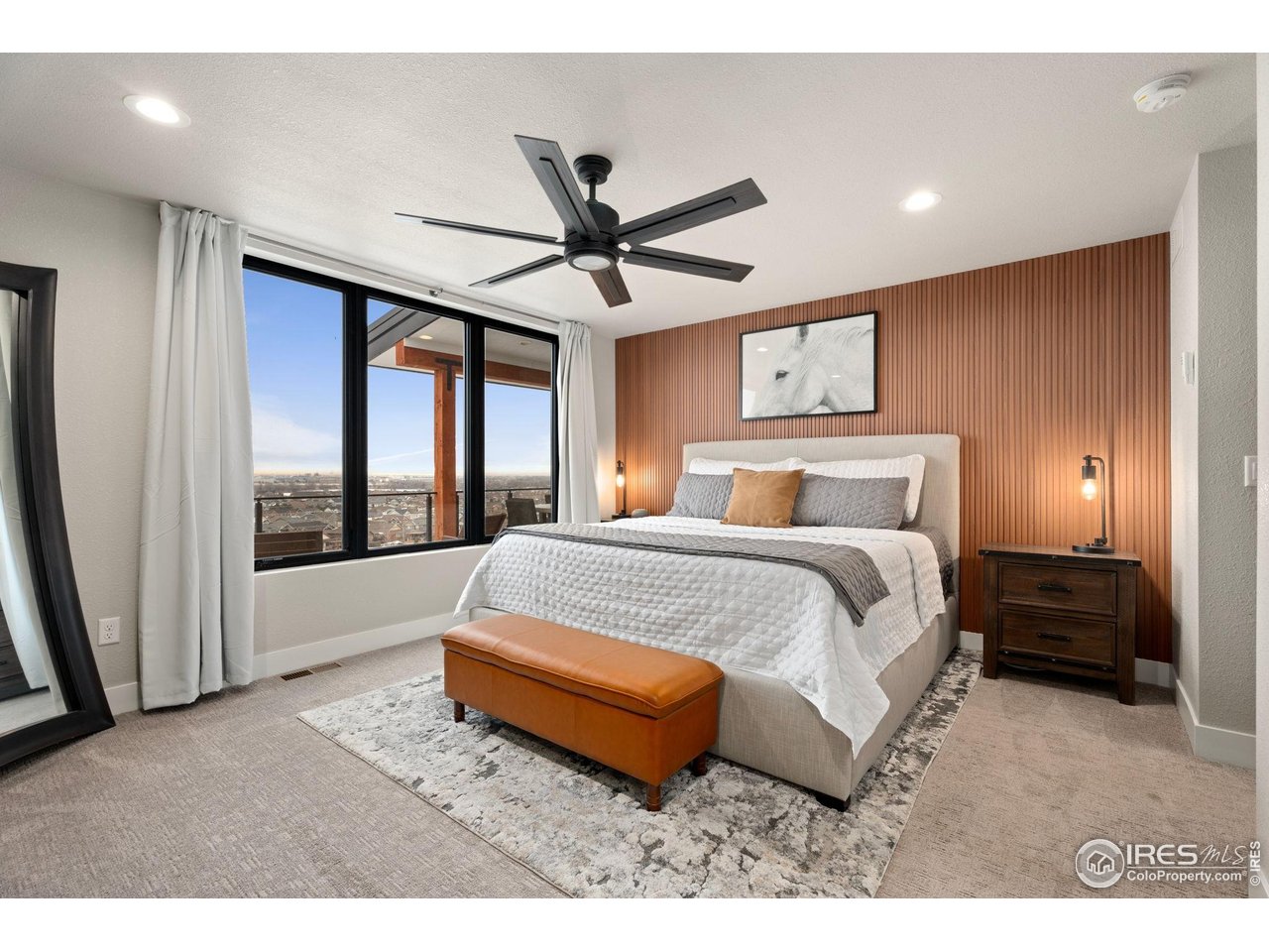 2089 Picture Point Drive Windsor, CO 80550 - Photo 16 of 45 a bedroom with a large bed and a chandelier