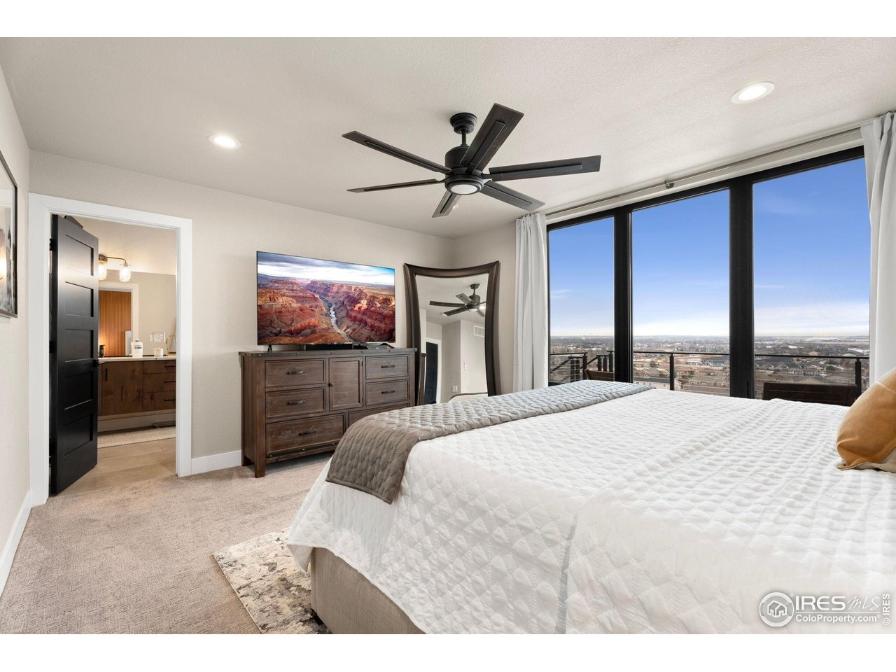 2089 Picture Point Drive Windsor, CO 80550 - Photo 17 of 45 a bedroom with a bed and a flat screen tv