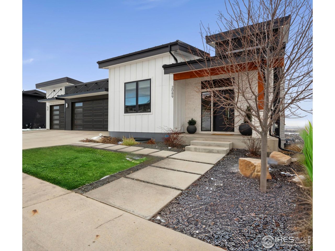 2089 Picture Point Drive Windsor, CO 80550 - Photo 2 of 45 a front view of a house with garden