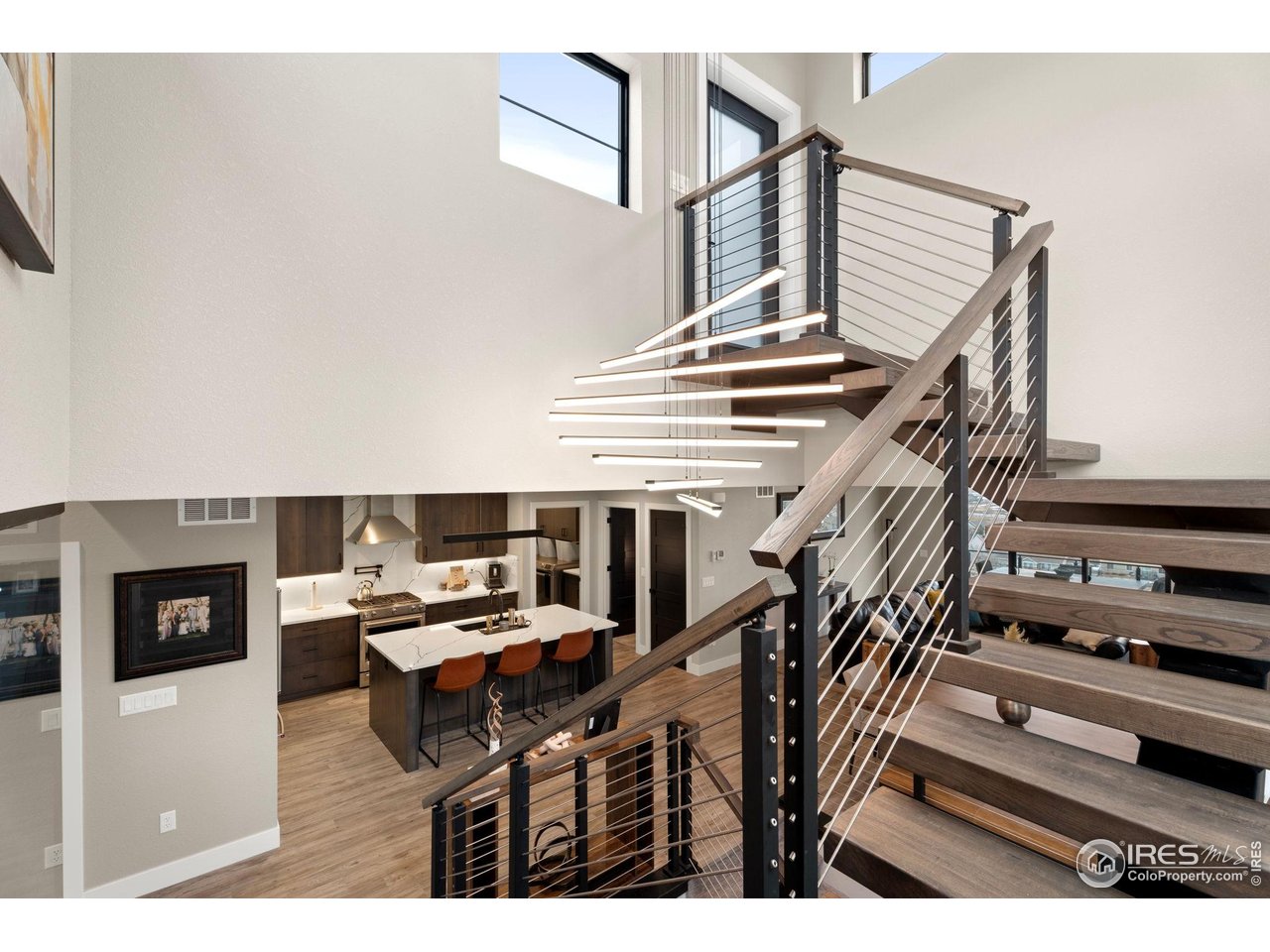 2089 Picture Point Drive Windsor, CO 80550 - Photo 30 of 45 a living room with furniture and a flat screen tv