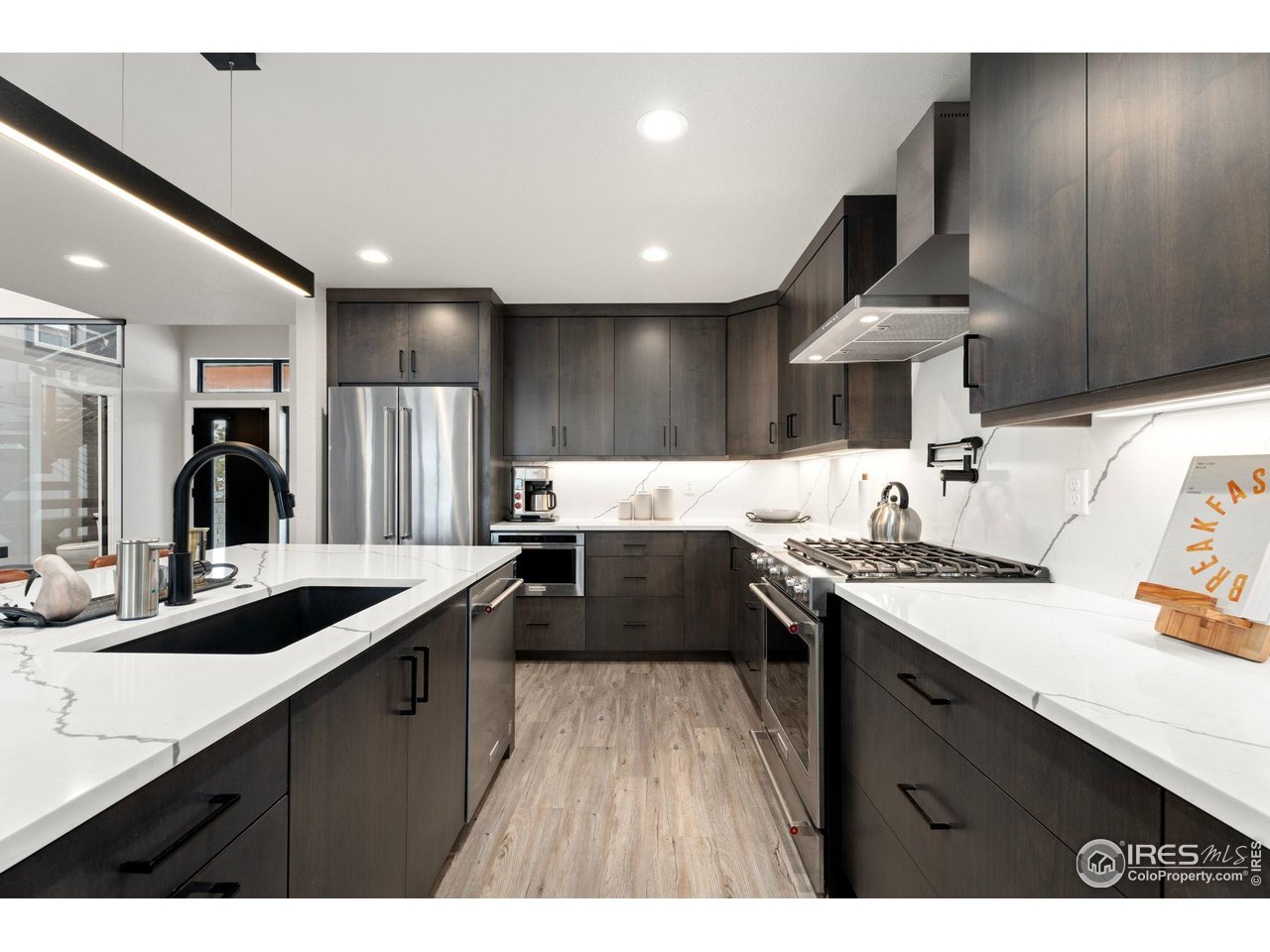 2089 Picture Point Drive Windsor, CO 80550 - Photo 9 of 45 a kitchen with granite countertop a sink stainless steel appliances and counter space
