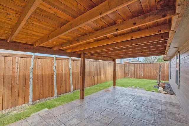 a view of a backyard with wooden fence