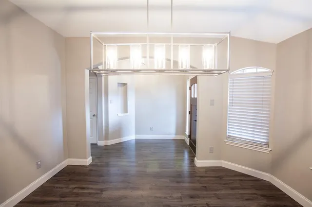 a view of a room with wooden floor