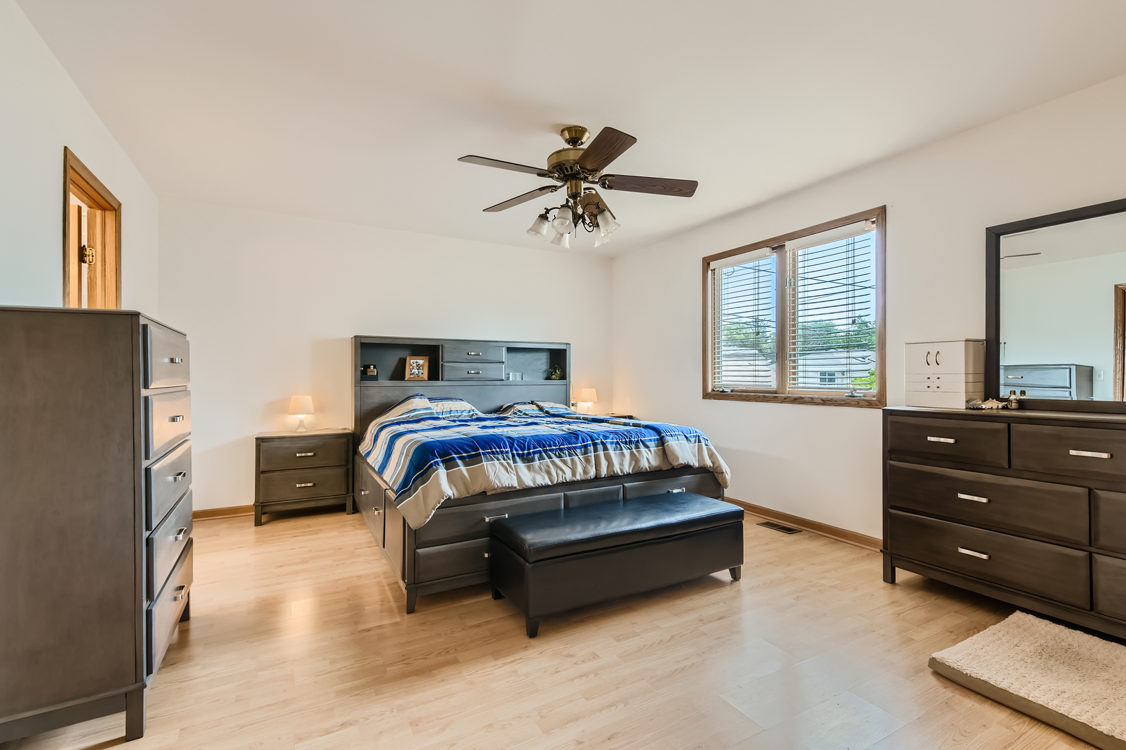 4057 Custer Avenue Lyons, IL 60534 - Photo 12 of 28 a bedroom with a bed and a chandelier