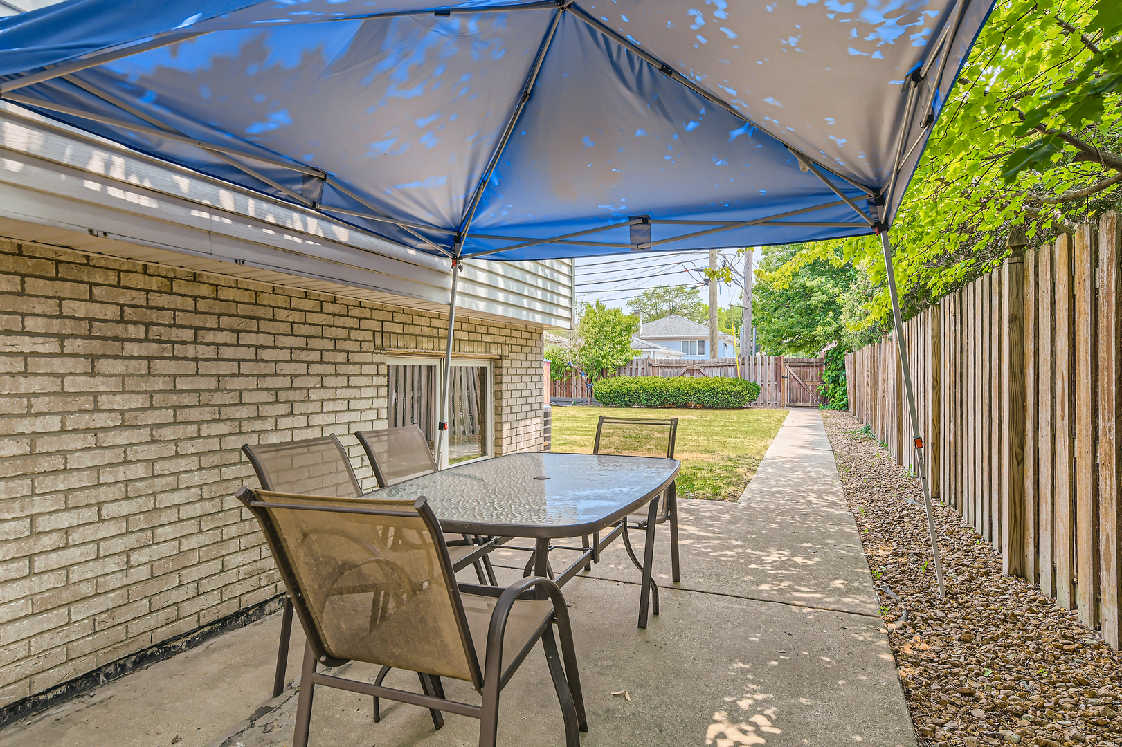 4057 Custer Avenue Lyons, IL 60534 - Photo 26 of 28 a view of a patio with a table and chairs under an umbrella