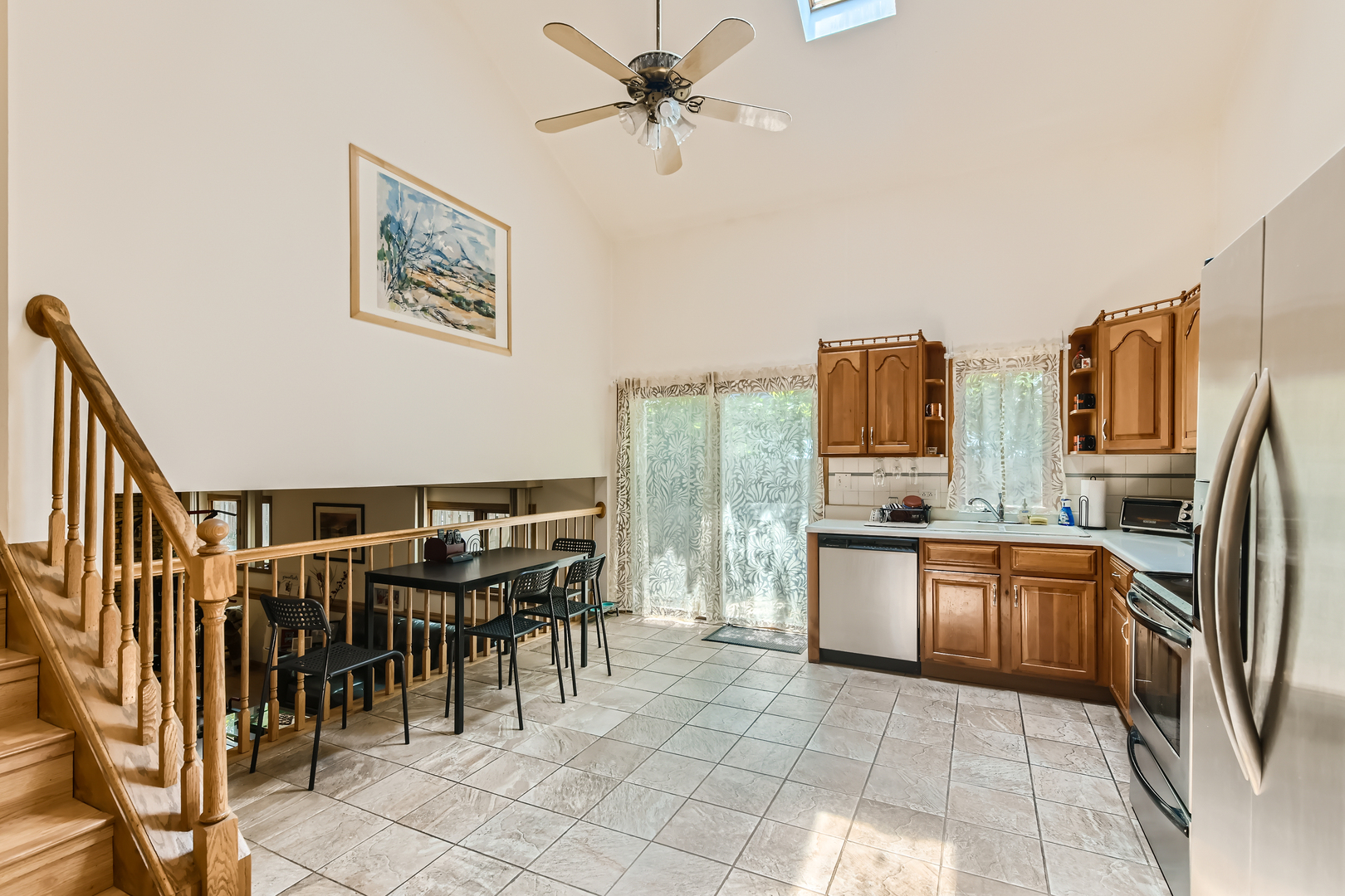 4057 Custer Avenue Lyons, IL 60534 - Photo 8 of 28 a open kitchen with stainless steel appliances granite countertop a refrigerator and chairs
